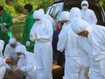 Captured in an unidentified location in China, this image depicts a group of Chinese epidemiologists, who were in the process of collecting data in the form of specimens, during an epidemiologic rickettsial investigation. These field workers were dressed in personal protective equipment (PPE), which covered their heads and bodies, in order to protect them from the possibility of tick bites, and an ensuing rickettsial disease.
